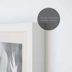 May include: A white picture frame with a black and white photo inside. The frame is made of thick, chunky wood. The text "Chunky Premium wooden frames" is visible in the upper right corner of the image.