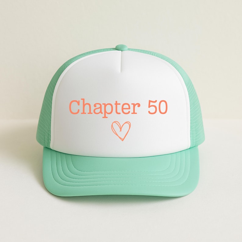 May include: A mint green and white trucker hat with the text "Chapter 50" in coral, along with a heart symbol. The hat has a curved brim and a mesh back.