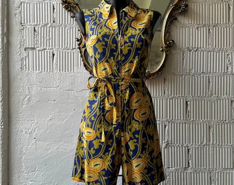 May include: A sleeveless blue and yellow floral print dress with a button-up front and a tie belt.