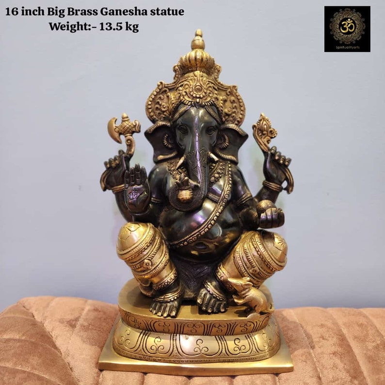 May include: A 16 inch tall black and gold brass Ganesha statue. The statue is sitting on a gold base with intricate designs. The statue weighs 13.5 pounds.