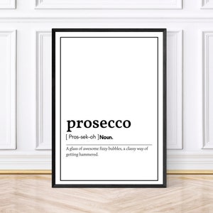 May include: Black framed print with the word "prosecco" in a bold font. Below, the definition reads: "A glass of awesome fizzy bubbles, a classy way of getting hammered."