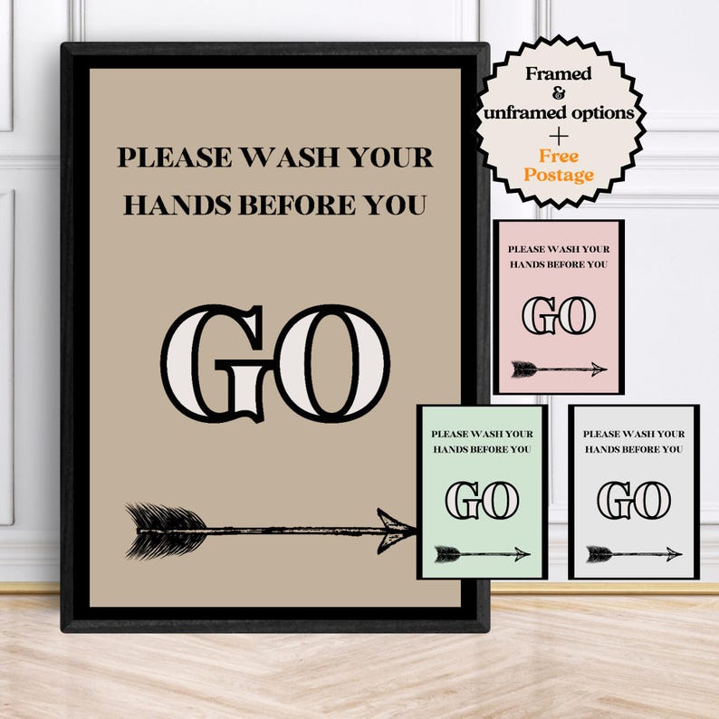 May include: A framed wall art print with the text "PLEASE WASH YOUR HANDS BEFORE YOU GO" in black. The word "GO" is in a large, bold font. An arrow points to the right. Additional smaller prints in pink, green, and gray are also shown.