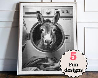 May include: Monochrome framed print showing a donkey inside a washing machine. The donkey's head is framed by the machine's door. A text bubble with the words "5 Fun designs" is visible. The print is displayed on a wall.