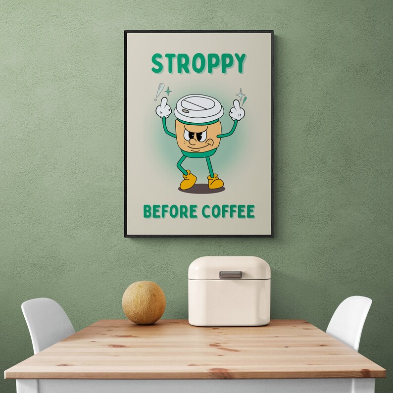 Może przedstawiać: Zielony i biały kresk&oacute;wkowy kubek do kawy z kwaśną miną i uniesionymi ramionami. Pod kubkiem znajduje się napis "STROPPY BEFORE COFFEE".