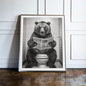 May include: A black and white photograph of a bear sitting on a toilet and reading a newspaper.