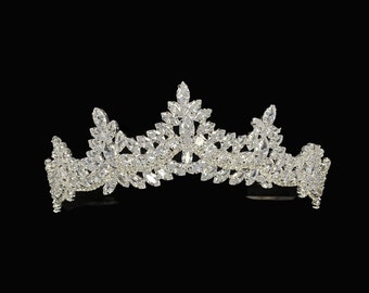 May include: A silver tiara with clear crystal embellishments in a leaf design.