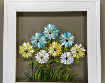 White, teal, and yellow daisies painted on glass.