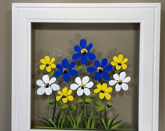 Blue, white, and yellow flowers painted on glass.