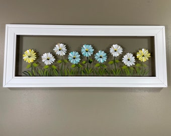 White, light teal and yellow daisies painted on glass.
