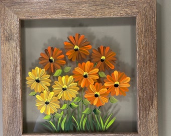 Yellow and orange daisies painted on glass.