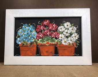 Teal and white daisies and geraniums in flower pots painted on screen.