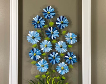 Blue daisies painted on glass.