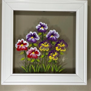 Pansies painted on glass.