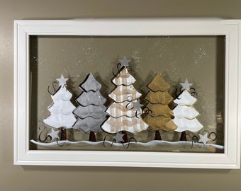 Gold, silver, and white trees painted on glass.