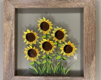 Sunflowers painted on glass.