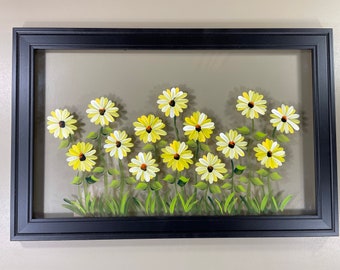 Yellow daisies painted on glass.