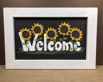 Sunflowers with Welcome painted on screen.