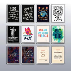 May include: A set of rectangular magnets featuring inspirational quotes and illustrations. Designs include a sloth, a butterfly, a teacup, and text such as "Wake up drink coffee kick ass" and "You're Doing Great."