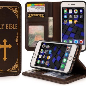 May include: A brown leather phone case designed to resemble a Holy Bible. The case has a gold cross and text on the front, with a wallet section inside. A smartphone is displayed inside the case.