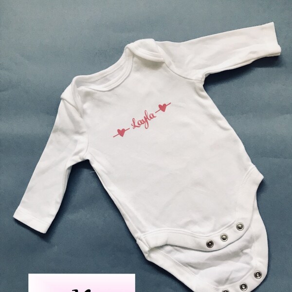 Pretty Personalised Baby Grow. Printed with name in stylish, cute font with sweet heart symbols. Custom made baby clothing, perfect as gift.