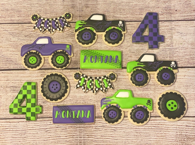 May include: A set of nine decorated sugar cookies featuring monster trucks, chequered flags, and the name "Montana". The cookies are decorated in shades of green, purple, and black.