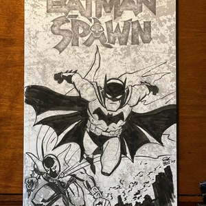 Puede incluir: Portada de cómic con una ilustración en blanco y negro de Batman y Spawn. El título "Batman Spawn" está en la parte superior, con los nombres McFarlane, Capullo y McCaig en la parte inferior. El fondo tiene un diseño texturizado y moteado.
