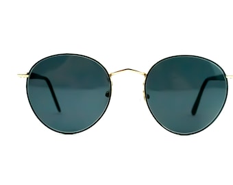 May include: Round black sunglasses with gold frames and dark lenses.