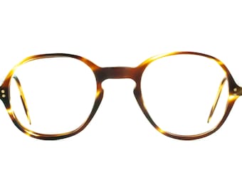 Puede incluir: Gafas de pasta de carey con monturas redondas y detalles dorados.