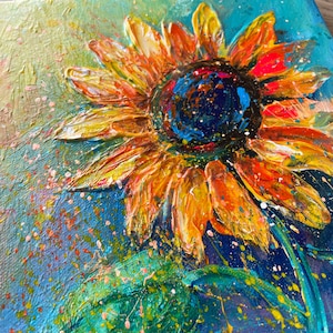 May include: Close-up of a vibrant sunflower painting. The petals are a mix of orange and yellow, with a textured, impasto style. The center is dark blue with colorful accents. The background is a blend of blue and green with paint splatters.
