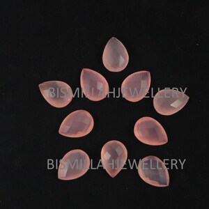 May include: Ten pink teardrop-shaped chalcedony gemstone beads. The beads are faceted and have a translucent appearance.