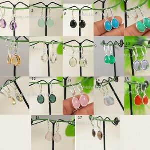 May include: A set of 17 pairs of sterling silver dangle earrings with various gemstone drops. The gemstones include amethyst, chalcedony, onyx, turquoise, green aventurine, citrine, clear quartz, rose quartz, moonstone, red agate, and smoky quartz.