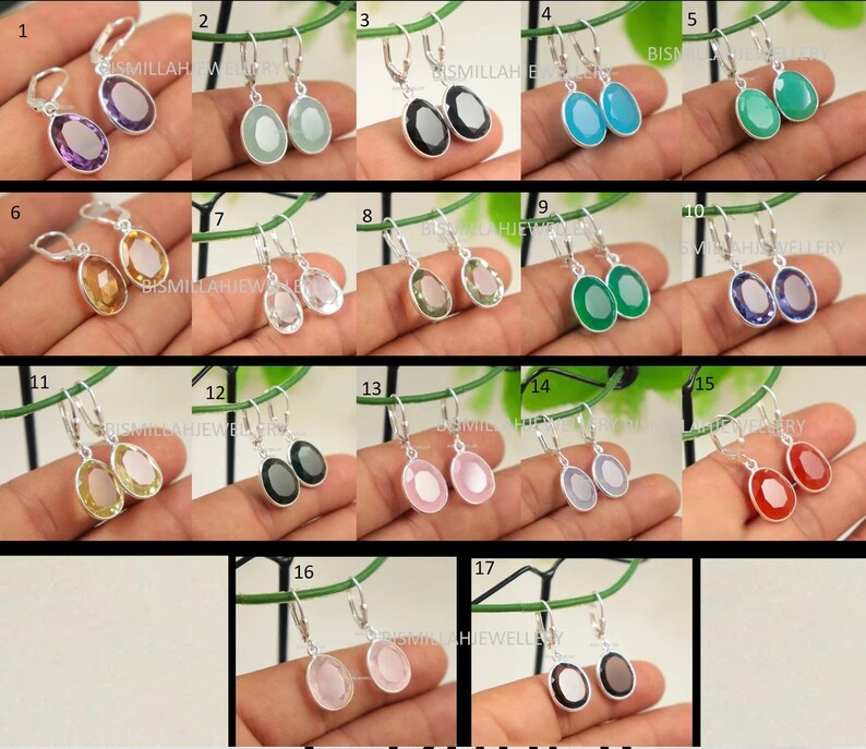 May include: A set of 17 pairs of silver dangle earrings with oval-shaped gemstones. The gemstones are in various colors, including purple, green, blue, red, pink, and clear.