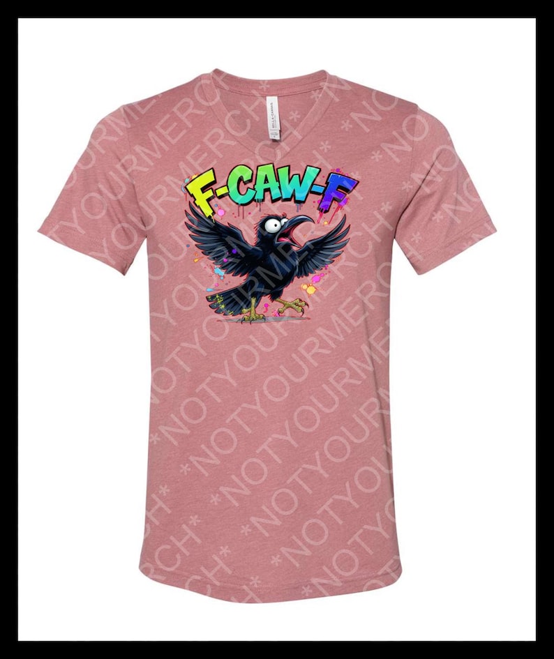May include: A mauve V-neck t-shirt featuring a cartoon crow with outstretched wings and the text "F-CAW-F" in colorful graffiti style. The crow has a wide open beak and is surrounded by colorful paint splatters.