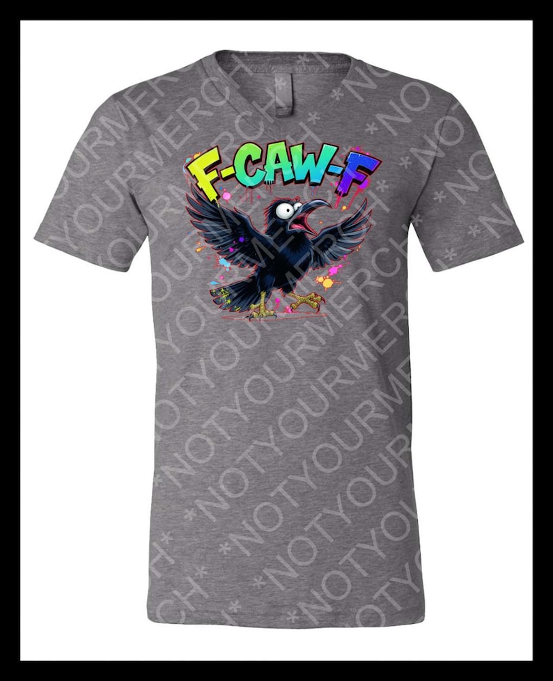 May include: Gray t-shirt featuring a cartoon crow with the text "F-CAW-F" in colorful graffiti-style lettering. The crow is black with its wings spread, and colorful paint splatters surround it.