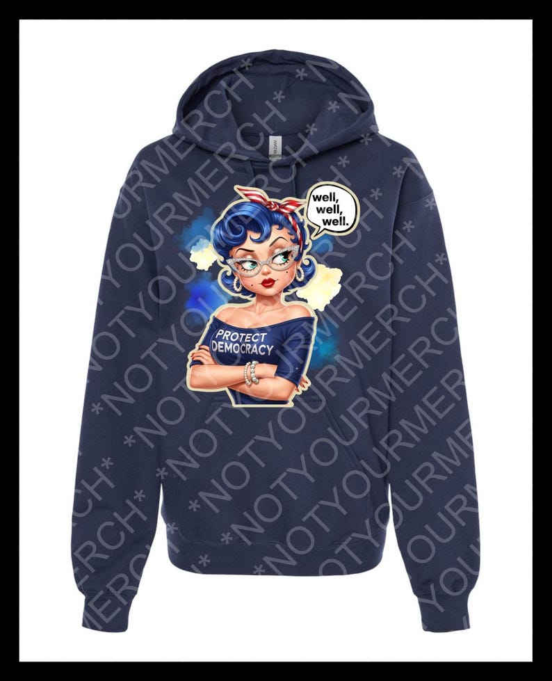 May include: A navy blue hoodie with a graphic of a woman with blue hair, glasses, and a red and white headband. The graphic includes the text "PROTECT DEMOCRACY" and a speech bubble saying "well, well, well."