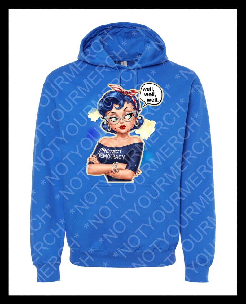 May include: A blue hooded sweatshirt with a graphic of a woman wearing a red headband and glasses. The graphic includes the text "PROTECT DEMOCRACY" and a speech bubble with "well, well, well." The hoodie has a drawstring hood.