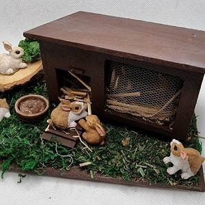 Dolls house miniatures&#39; BunnyVille&#39; Bunnies being bunnies in Bunnyville with straw, a cosy hutch, water, cabbage, waiting for some carrots
