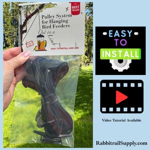 May include: A pulley system for hanging bird feeders in a clear plastic bag with a header card featuring the text Pulley System for Hanging Bird Feeders, Out on a Limb, Best Seller, Made in USA, and Easy to Install and Use, plus a metal cleat.