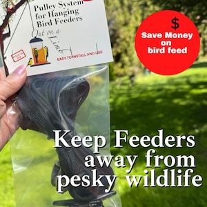 May include: A pulley system for hanging bird feeders packaged in a clear plastic bag with a white header card. The card features the text Pulley System for Hanging Bird Feeders, Out on a Limb, EASY TO INSTALL AND USE, and MADE IN USA.