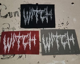 May include: Three rectangular patches with the word "WITCH" in a stylized, dripping font. The patches are black, red, and gray, with the text in white. The patches are likely for clothing or accessories.