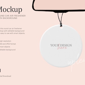 May include: Mockup of a white round car air freshener hanging from a rearview mirror. The air freshener has the text "YOUR DESIGN here" on it.