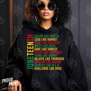 May include: Black hoodie with the words "Juneteenth" and a list of inspirational quotes about African American leaders, including "Dream Like Martin", "Lead Like Harriet", "Fight Like Malcolm", "Write Like Maya", "Dare Like Shirley", "Speak Like Frederick", "Think Like Garvey", "Believe Like Thurgood", "Reclaim Like Maxine", "Educate Like W.E.B.", and "Challenge Like Rosa".