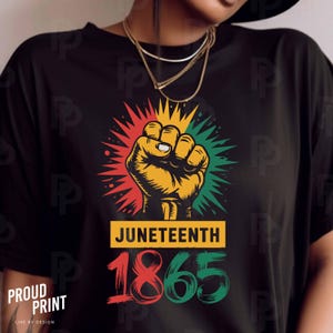 May include: Black t-shirt with a red, yellow, and green graphic of a raised fist. The graphic has a starburst design and the text "Juneteenth 1865".