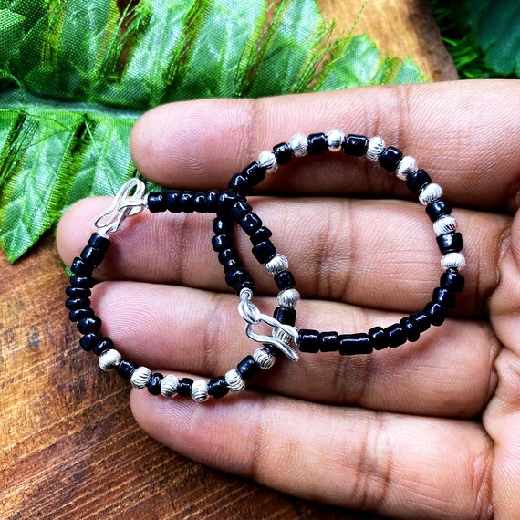 Silver baby bracelets with black best sale beads