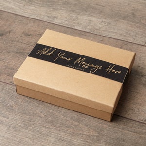 May include: A brown cardboard gift box with a black ribbon and the text "Add Your Message Here" in gold lettering.