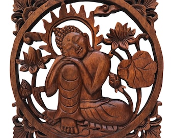 May include: A brown wooden wall hanging with a carved image of a meditating Buddha surrounded by lotus flowers. The Buddha is sitting with their eyes closed and their hands in their lap.