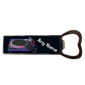 May include: A black and silver bottle opener featuring a graphic of a DJ turntable and the text "Any Name" on a black background.