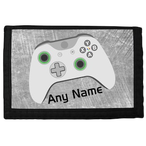 May include: A black wallet with a white and grey design featuring a video game controller with the text "Any Name".