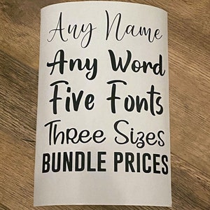 May include: A white sheet of paper with black text that reads "Any Name Any Word Five Fonts Three Sizes Bundle Prices".