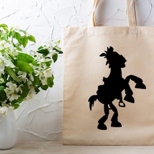 May include: A beige tote bag with a black silhouette of a horse and rider. The horse is rearing up on its hind legs.